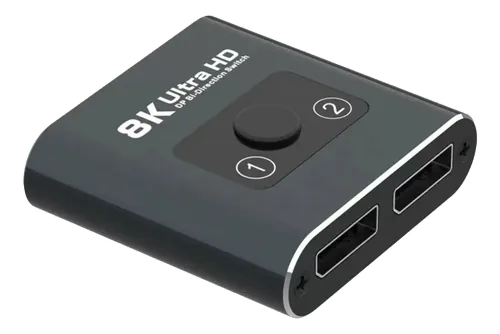Switch DisplayPort preto em ângulo, com botão seletor e uma entrada e duas saídas DisplayPort.